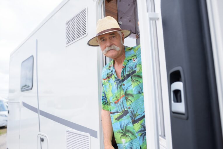 senior citizen with travel trailer