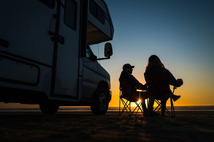 RV couple relaxing at sunset