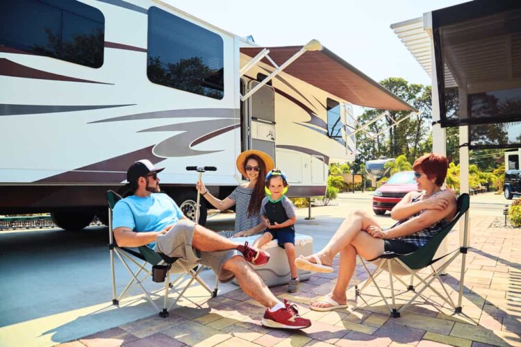 RV family relaxing with kid