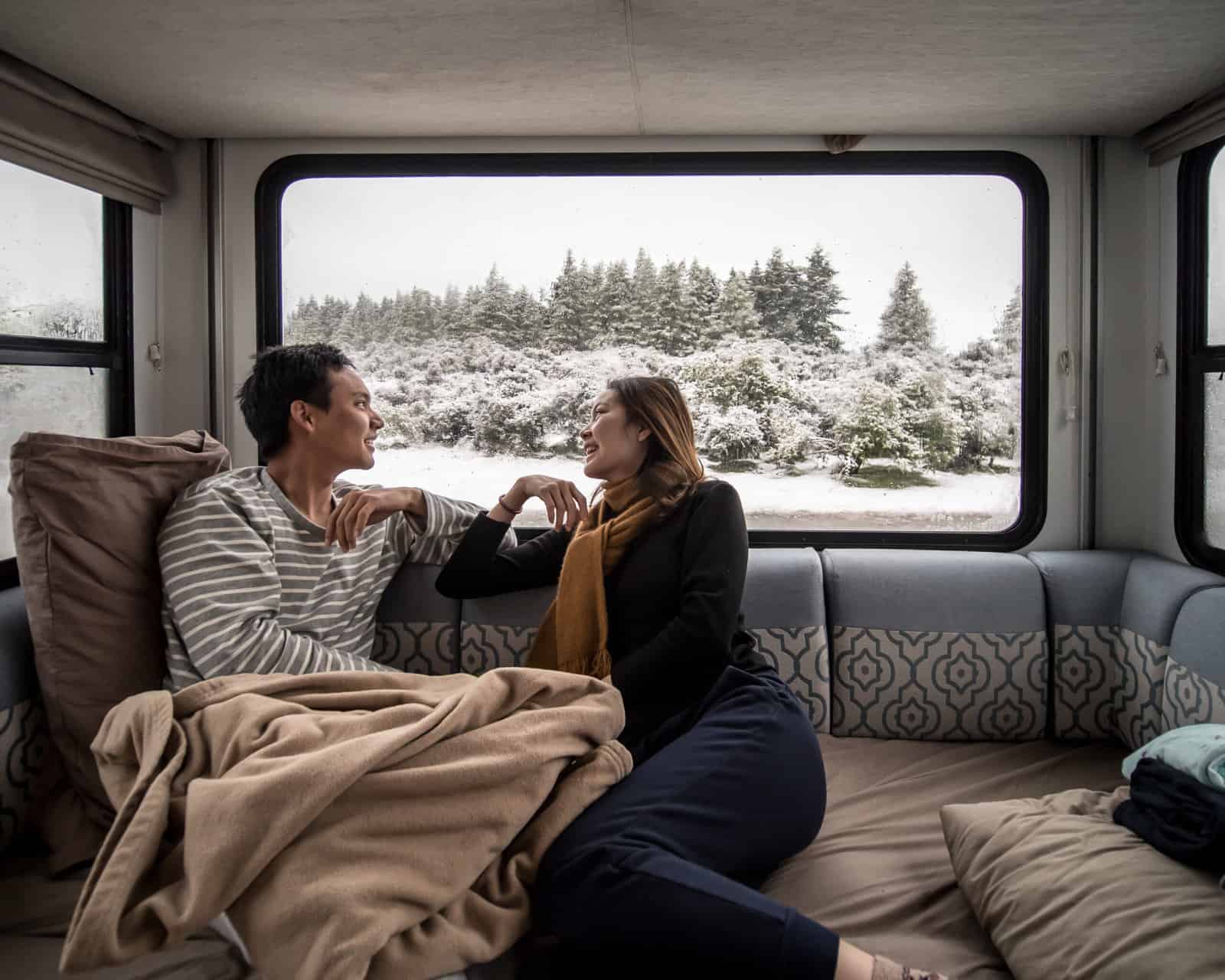 comfy couple with winter RV camping must-haves