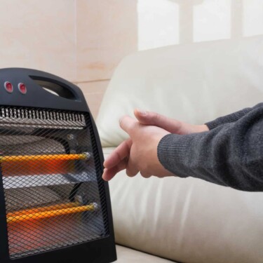 warming hands with electric RV space heater