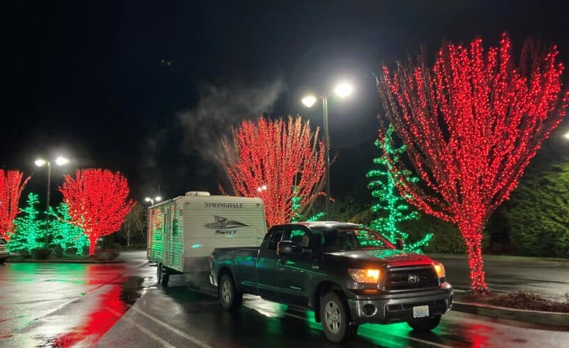 RV holiday lights with travel trailer and truck in parking lot (Image: Dave Helgeson)
