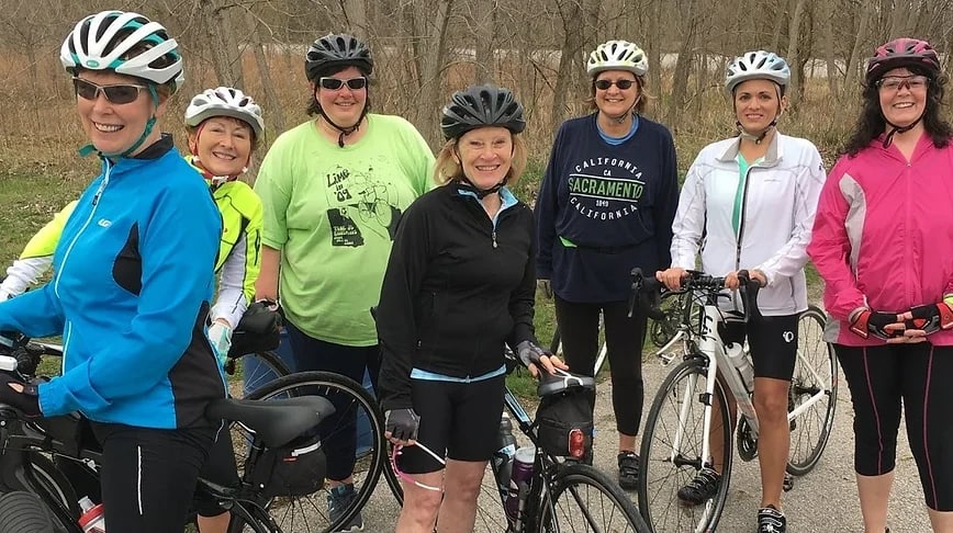 Several women gathered together for a Blazing New Trails bike ride.