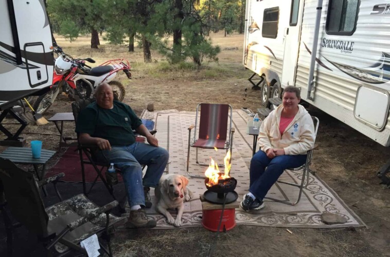 Friends enjoy a portable gas fire during a campfire ban