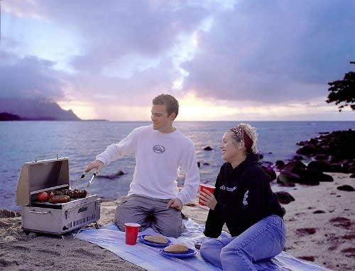 Couple grilling with a Solaire SOL-EV17A portable gas grill (Image: Amazon)