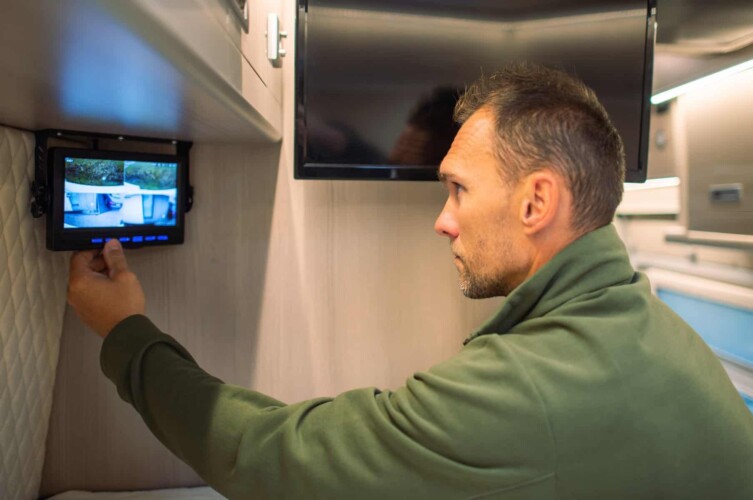 Man reviewing RV security camera. (Image: Shutterstock)