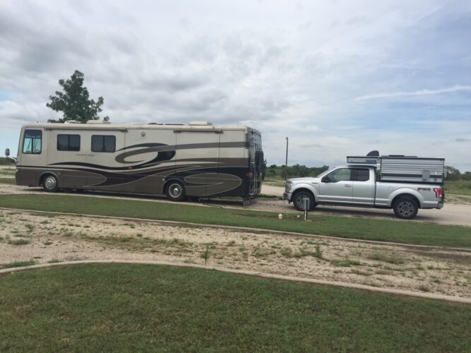 Full-time RVing motorhome with a pop-up truck camper tow vehicle. . (Image: Larri Chiuppi)